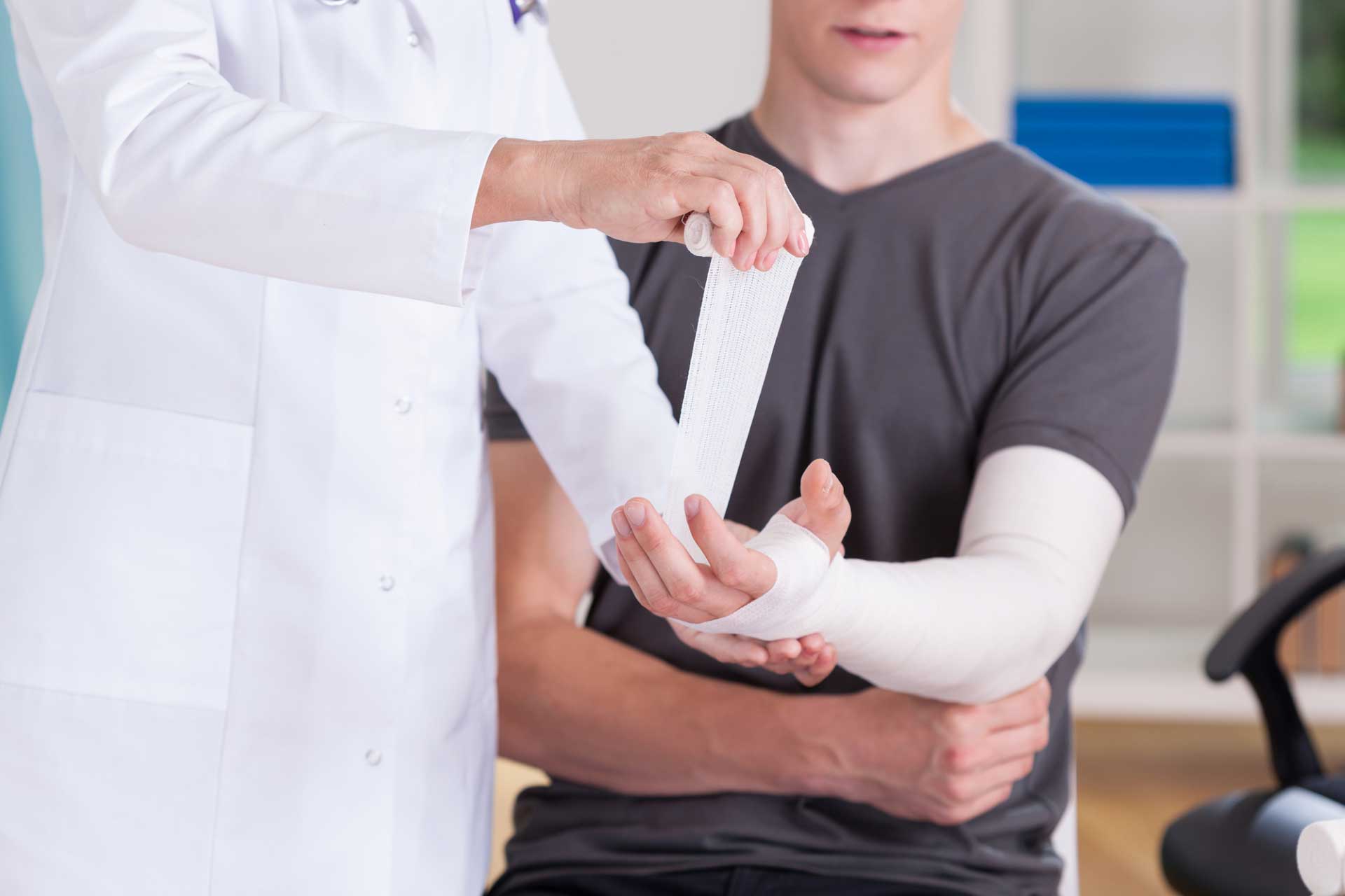A doctor putting on a cast on a broken arm in a Pocatello Urgent Care